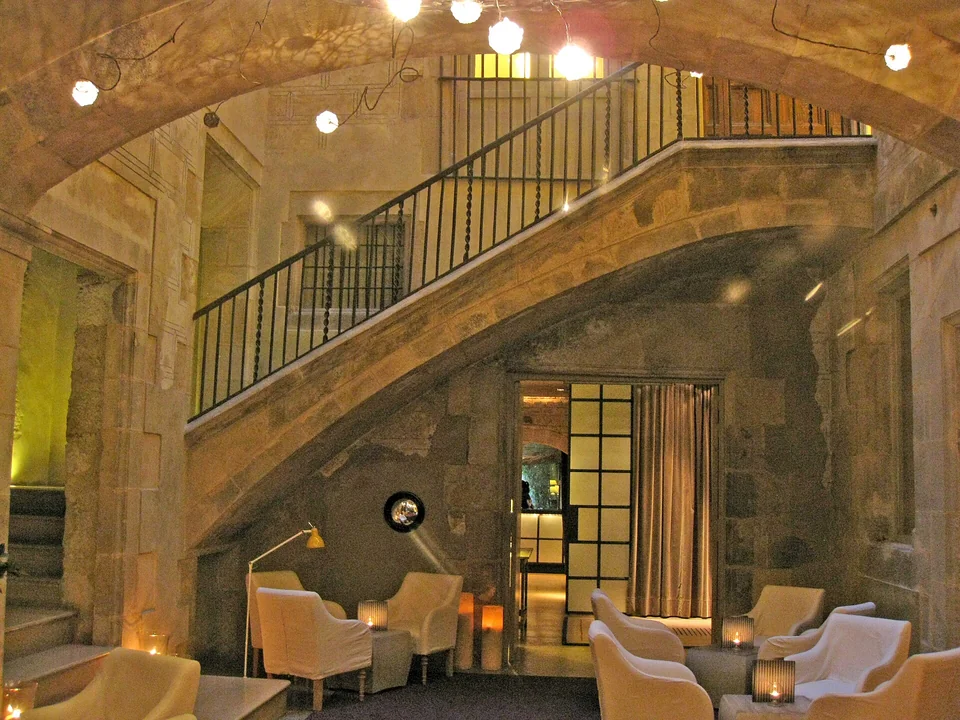 Hotel Neri courtyard with medieval stone arches and terrace, Gothic Quarter Barcelona