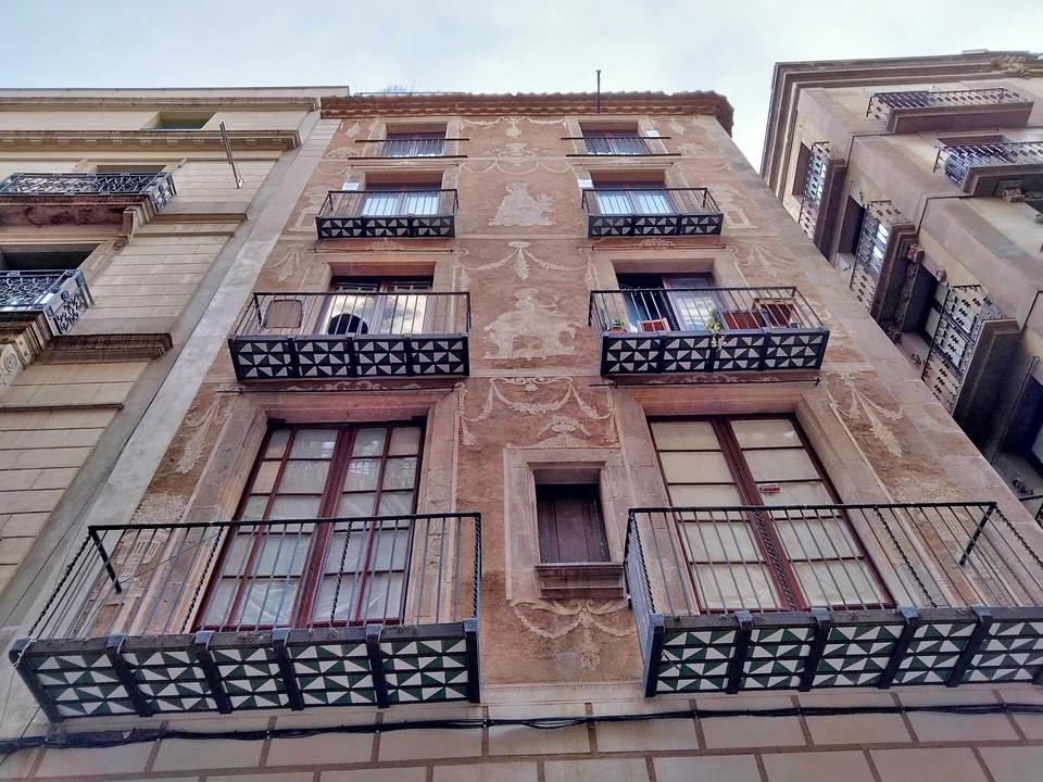 Historic 19th-century architectural facade on Carrer de la Boqueria near La Rambla, Barcelona